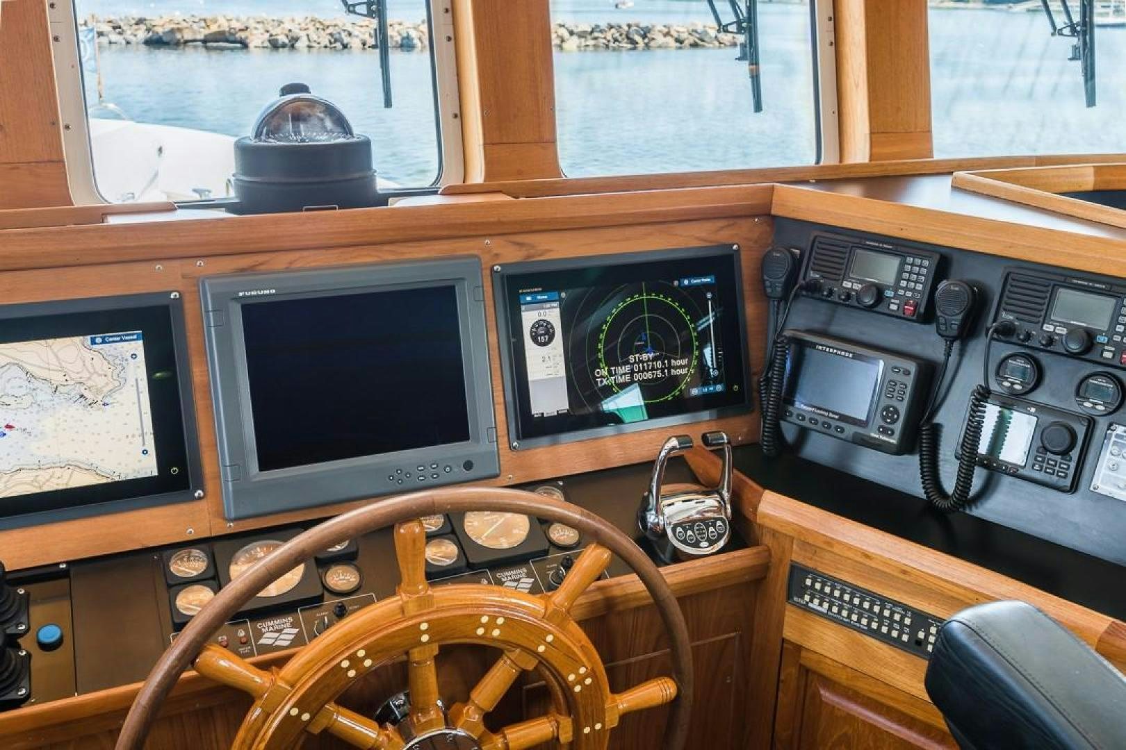 a desk with computers and a television aboard HERCULES Yacht for Sale