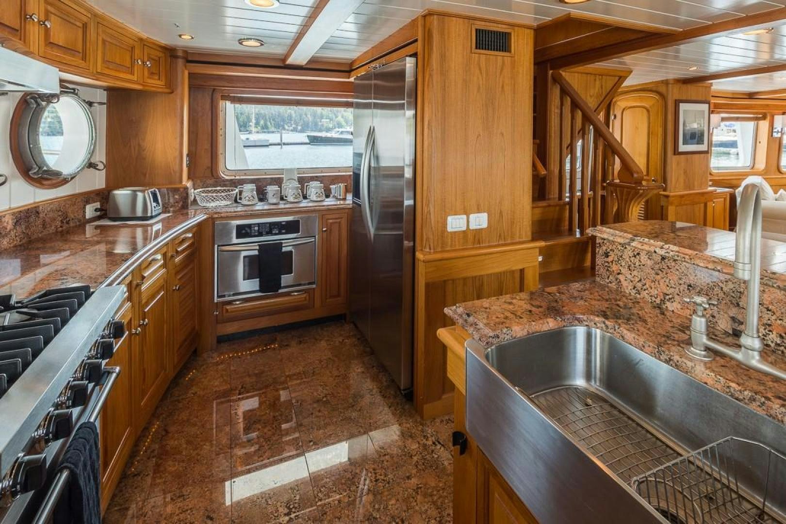 a kitchen with wooden cabinets aboard HERCULES Yacht for Sale