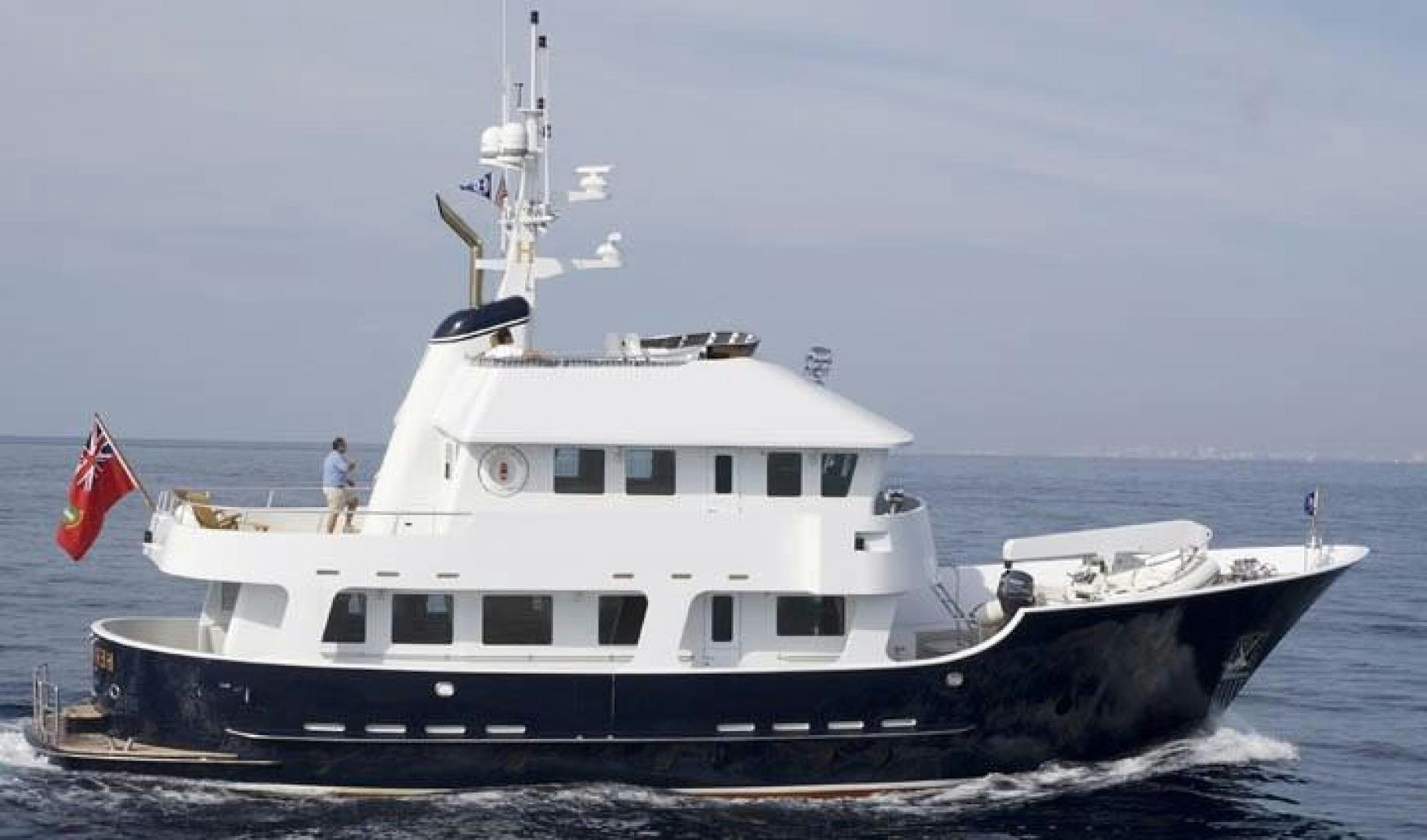 a large white boat with a flag on the front aboard HERCULES Yacht for Sale