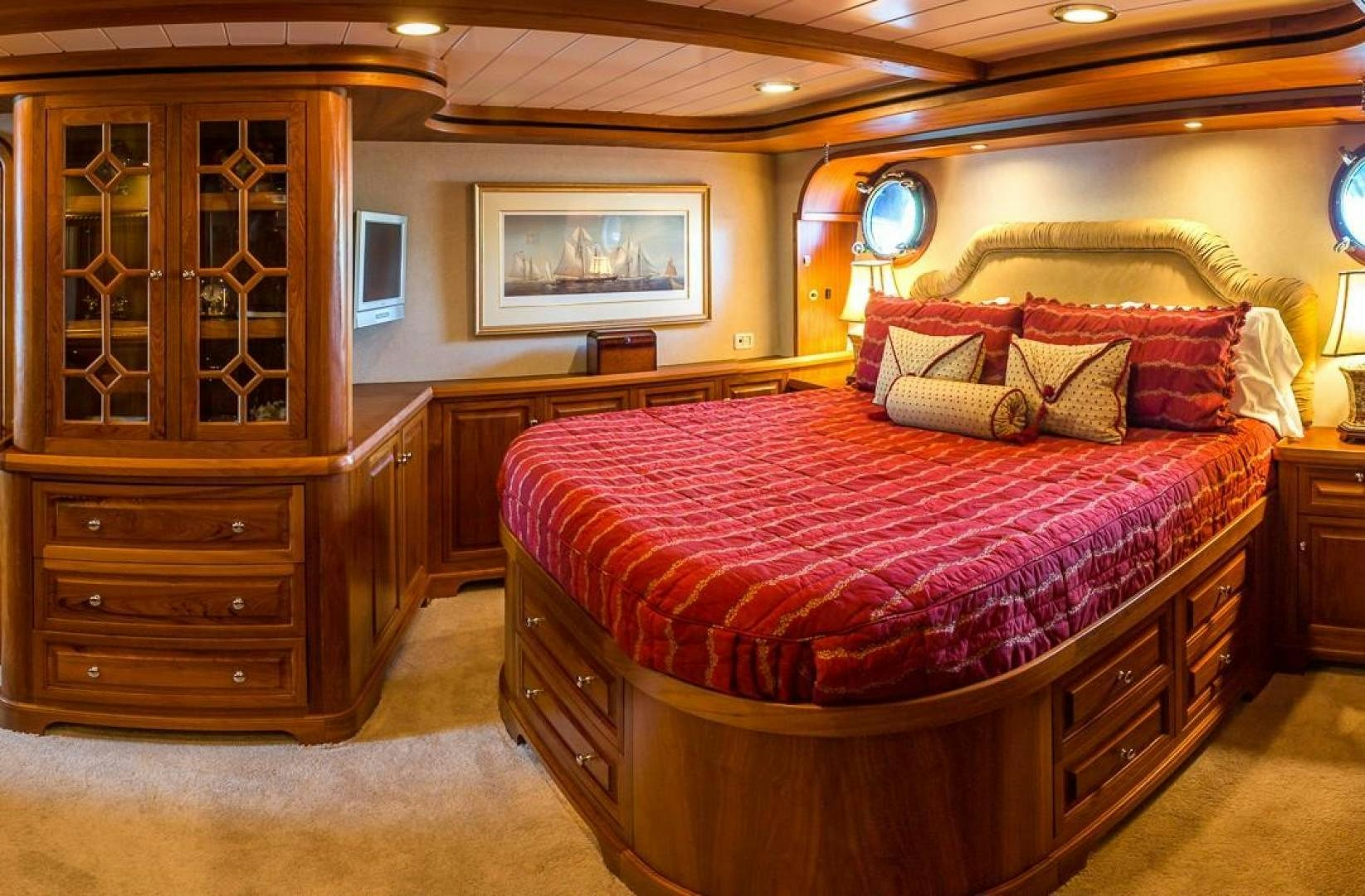 a bedroom with a bed and a dresser aboard HERCULES Yacht for Sale