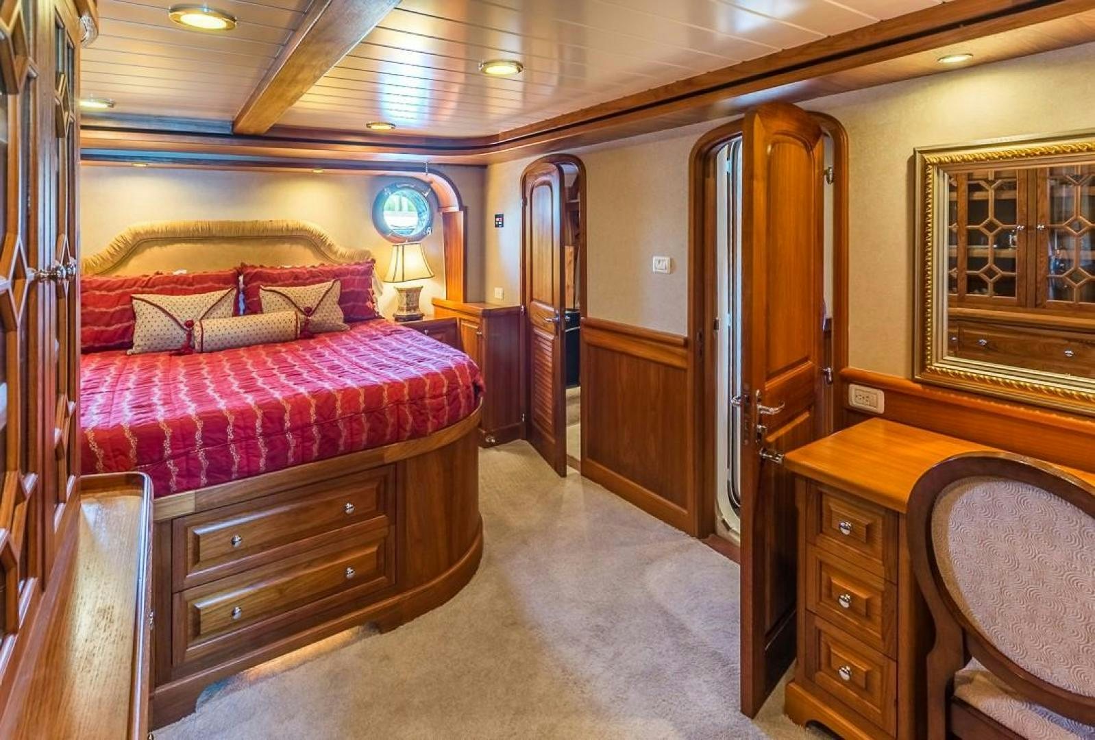 a bedroom with a bed and desk aboard HERCULES Yacht for Sale