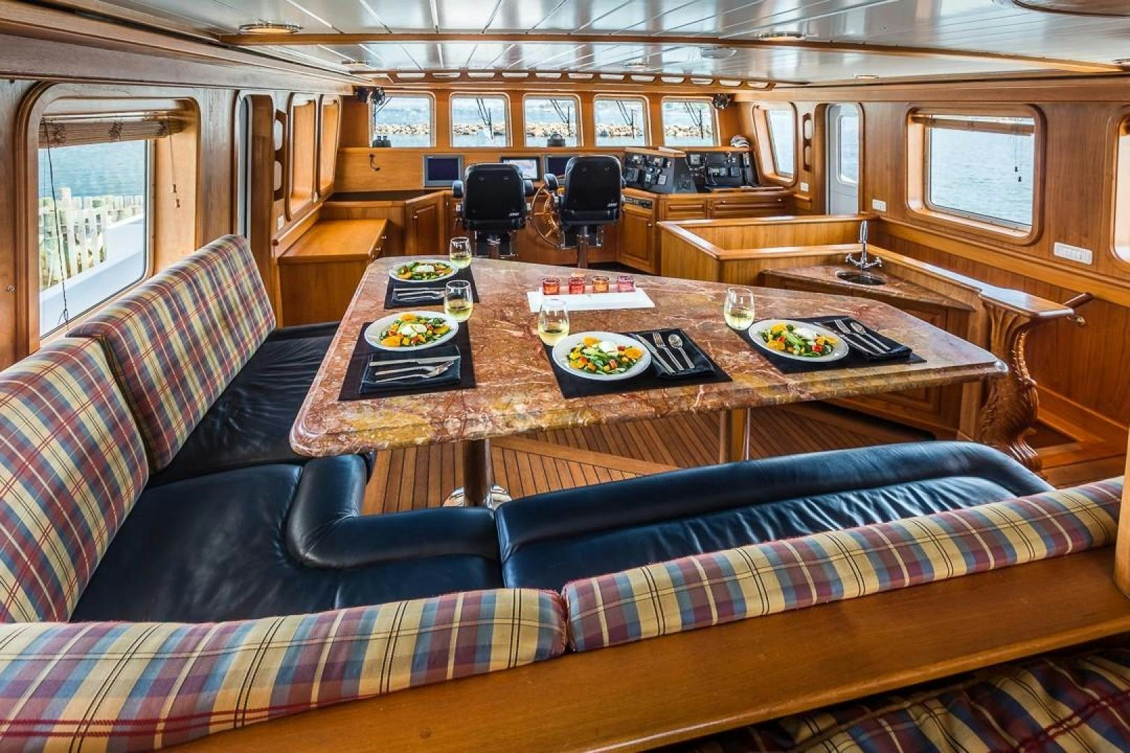 a living room with a couch and a table aboard HERCULES Yacht for Sale