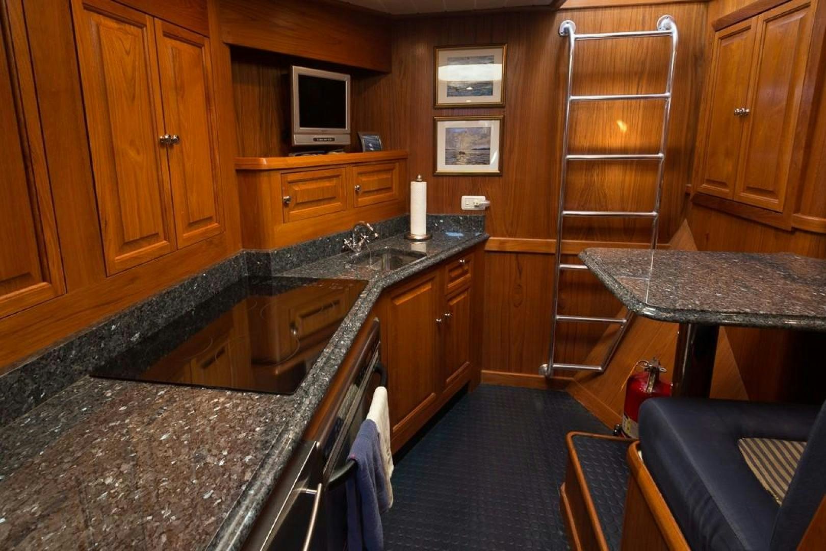 a kitchen with a bar and a ladder aboard HERCULES Yacht for Sale