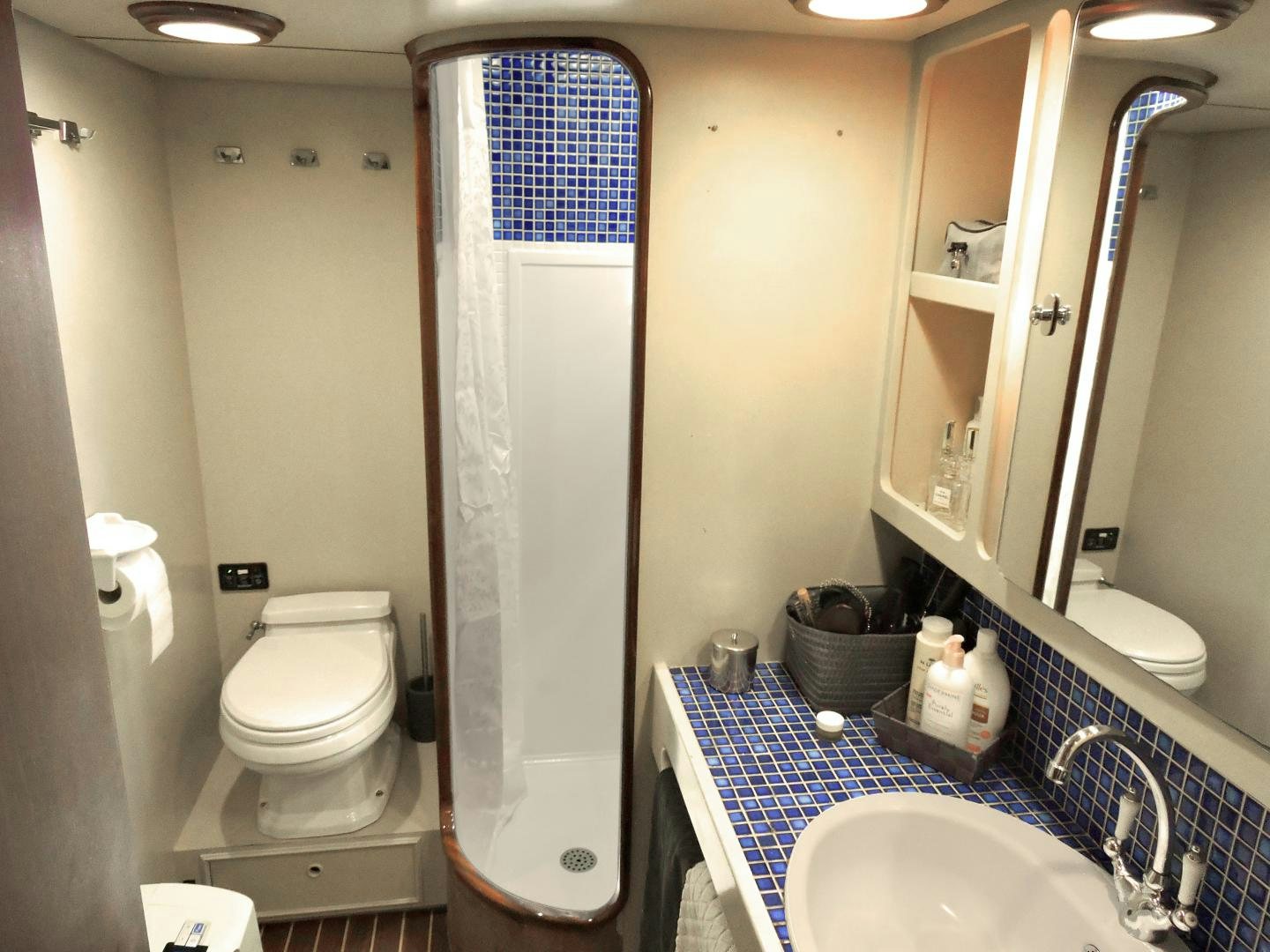 a bathroom with a shower and toilet aboard WHITE GARUDA Yacht for Sale