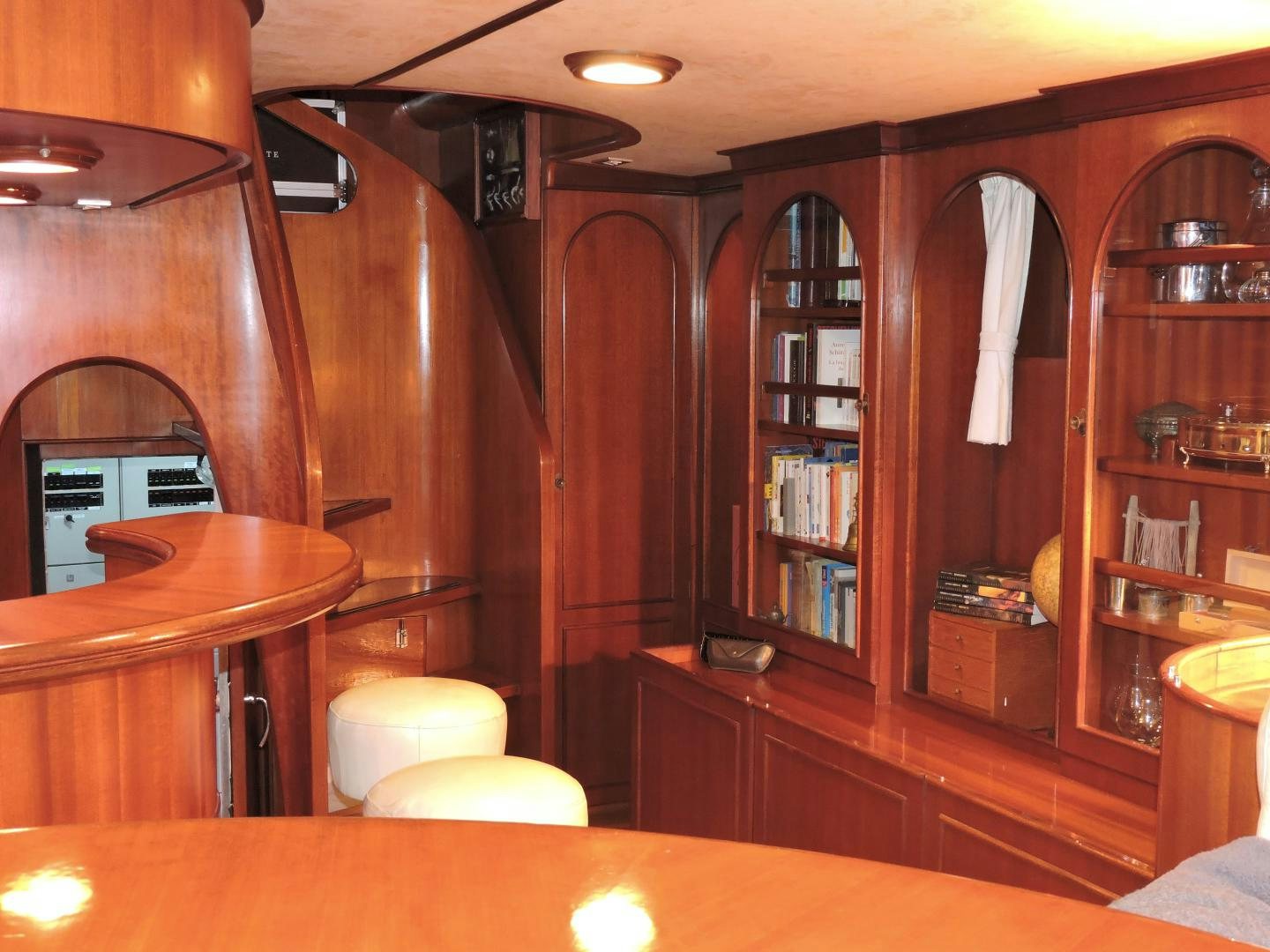 a room with a table and bookshelves aboard WHITE GARUDA Yacht for Sale