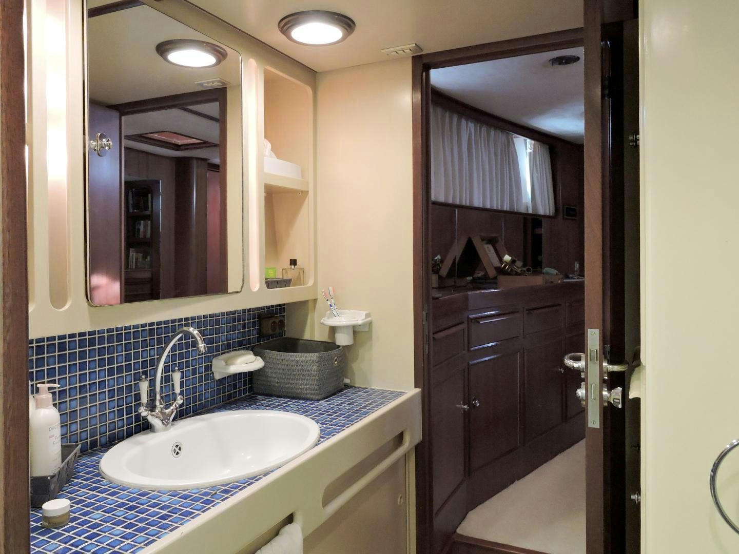 a bathroom with a sink and a mirror aboard WHITE GARUDA Yacht for Sale