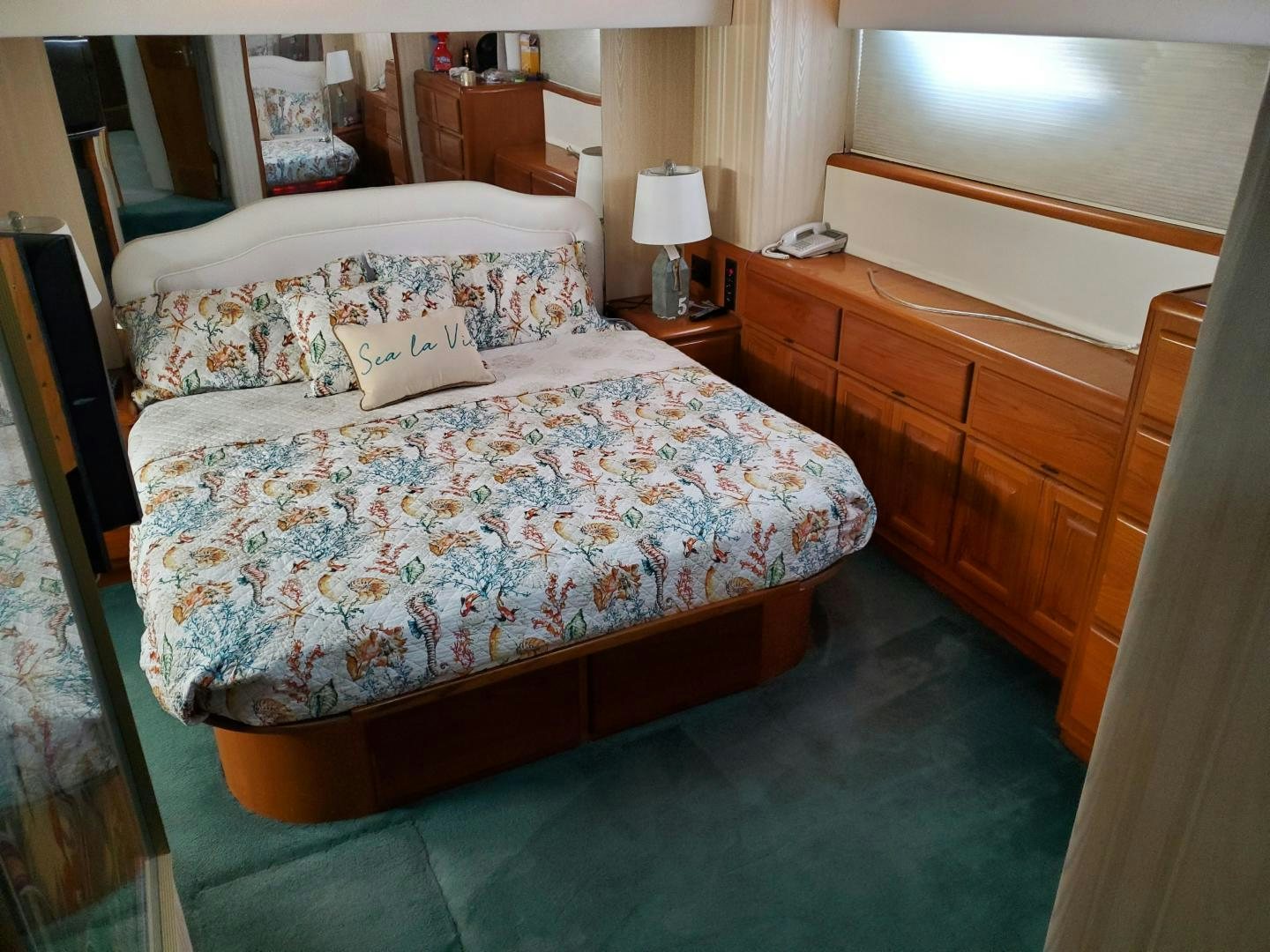 a bed with a white comforter aboard No Name Yacht for Sale