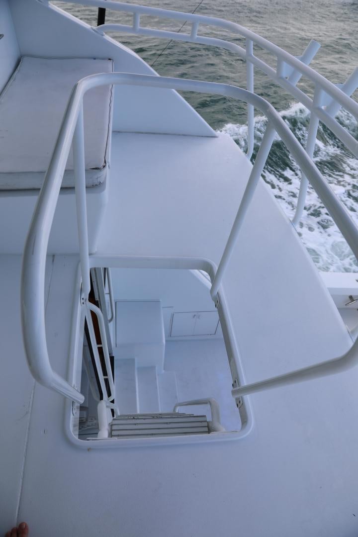 a white boat on the beach aboard No Name Yacht for Sale