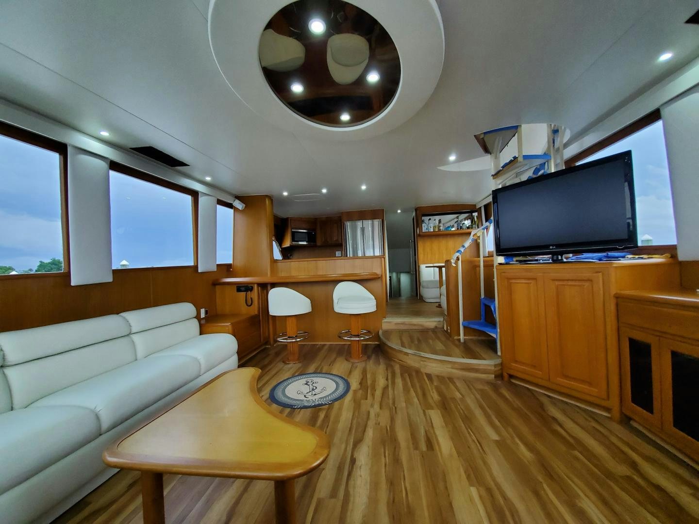 a living room with a large mirror aboard No Name Yacht for Sale