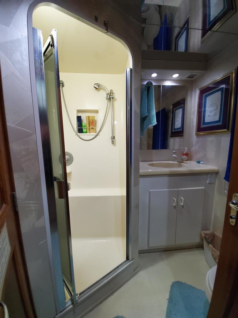 a bathroom with a glass shower door aboard No Name Yacht for Sale