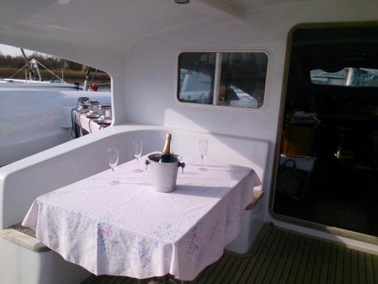a table with a pink cloth on it and a white table with a pink cloth on it and aboard No Name Yacht for Sale