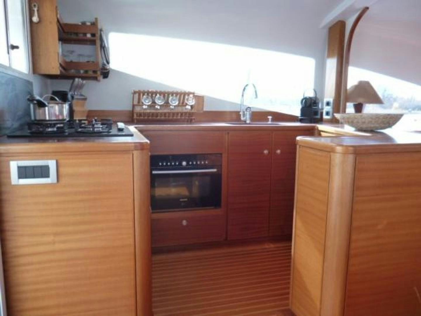 a kitchen with wooden cabinets aboard No Name Yacht for Sale