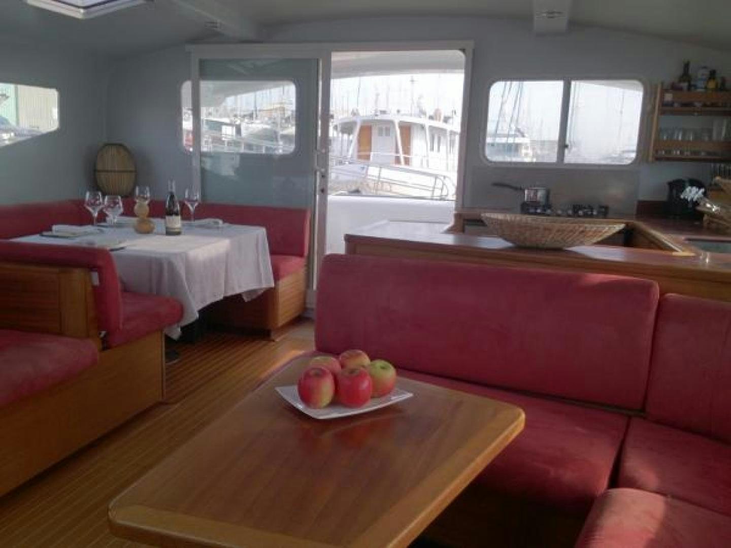 a living room with a table and couches aboard No Name Yacht for Sale