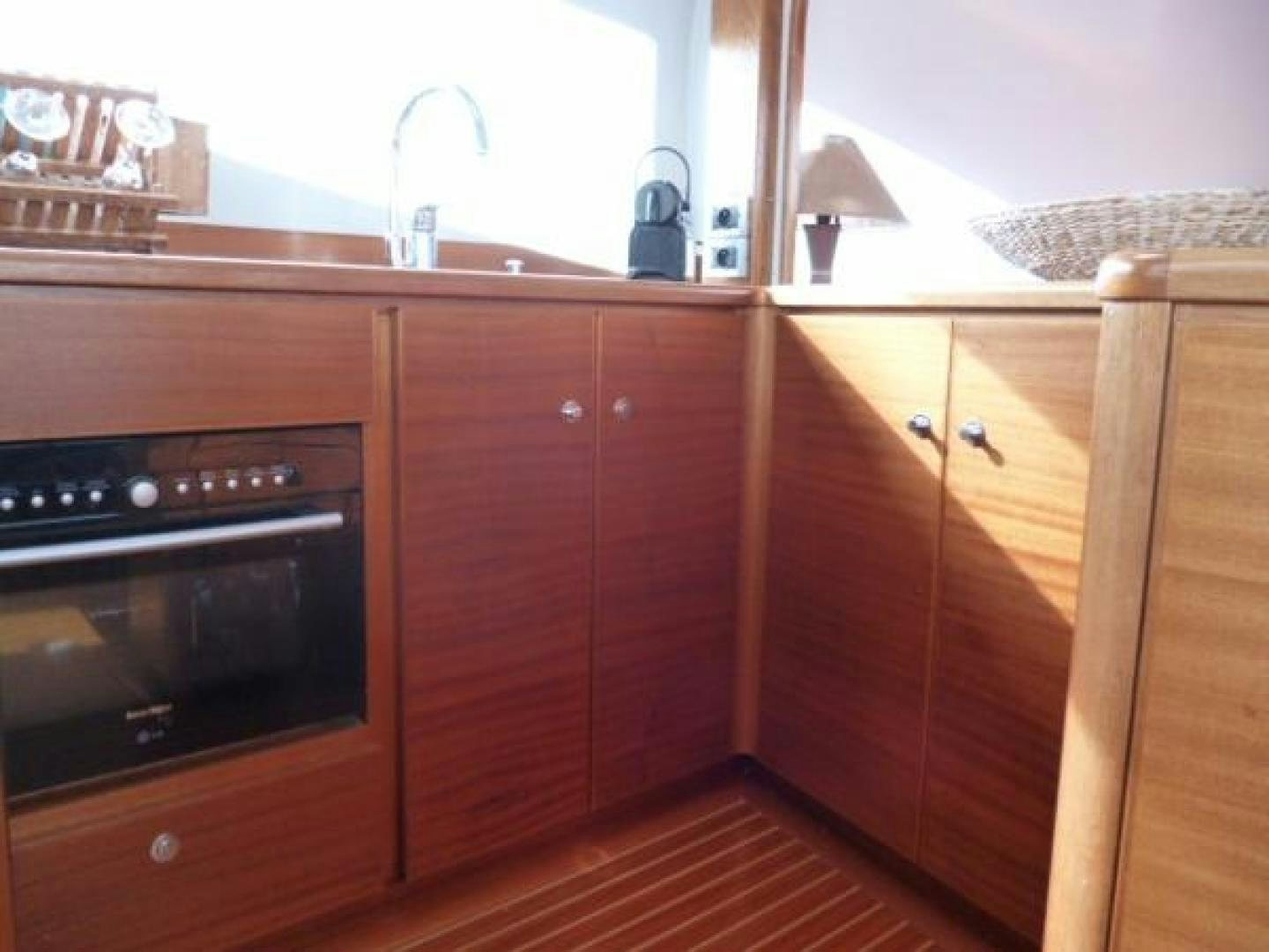 a kitchen with wooden cabinets aboard No Name Yacht for Sale