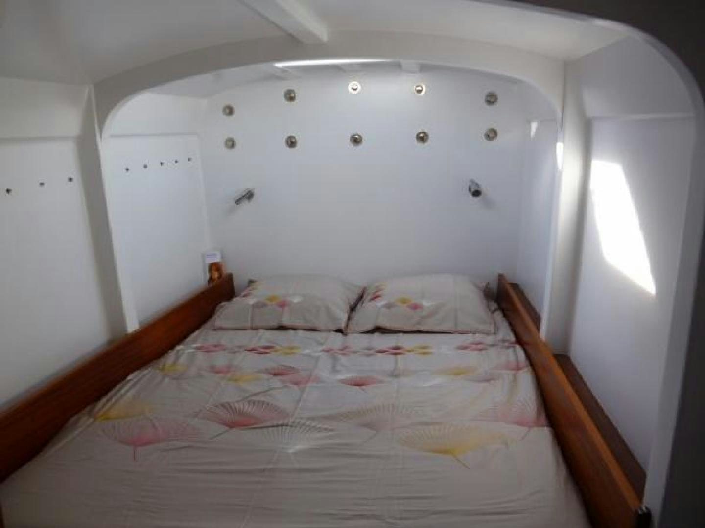 a bed with a whiteboard aboard No Name Yacht for Sale