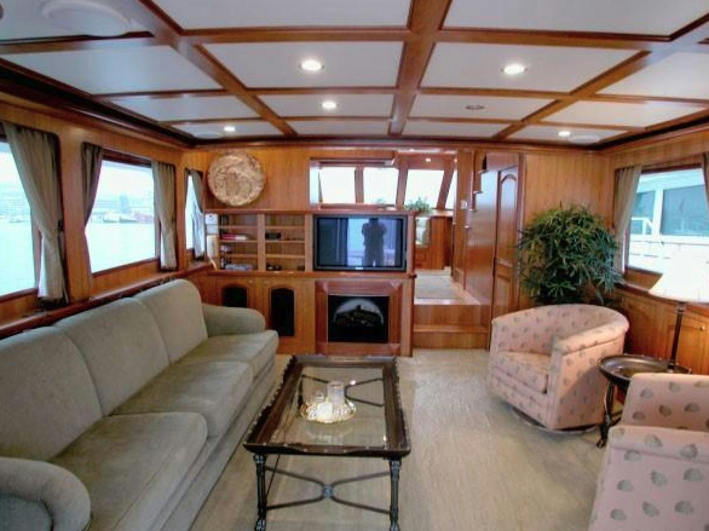 a living room with a fireplace aboard No Name Yacht for Sale