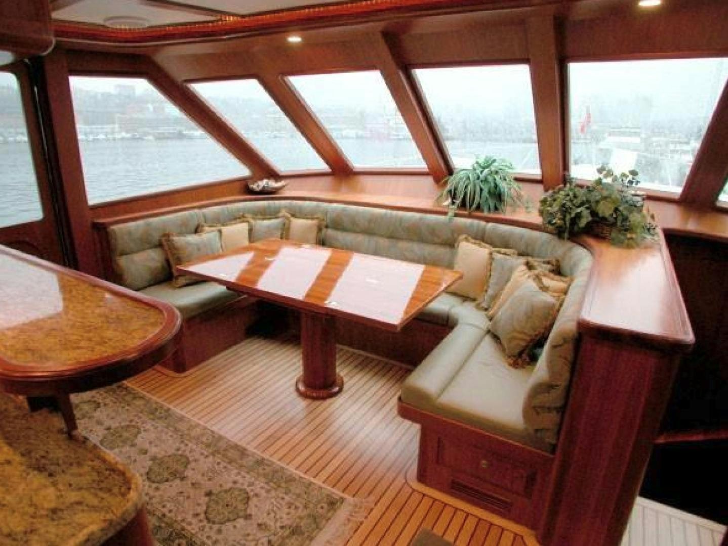 a living room with a couch and a table aboard No Name Yacht for Sale