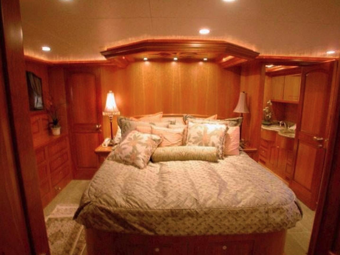 a bed with a white comforter aboard No Name Yacht for Sale