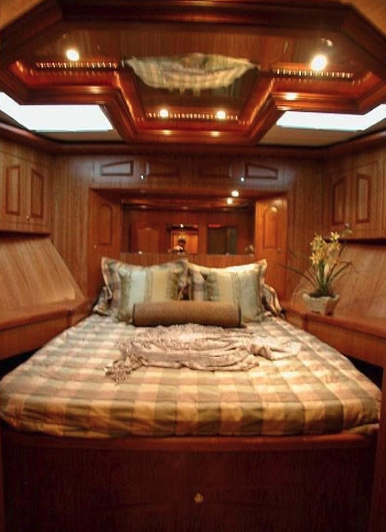 a bed with a large mirror above it aboard No Name Yacht for Sale