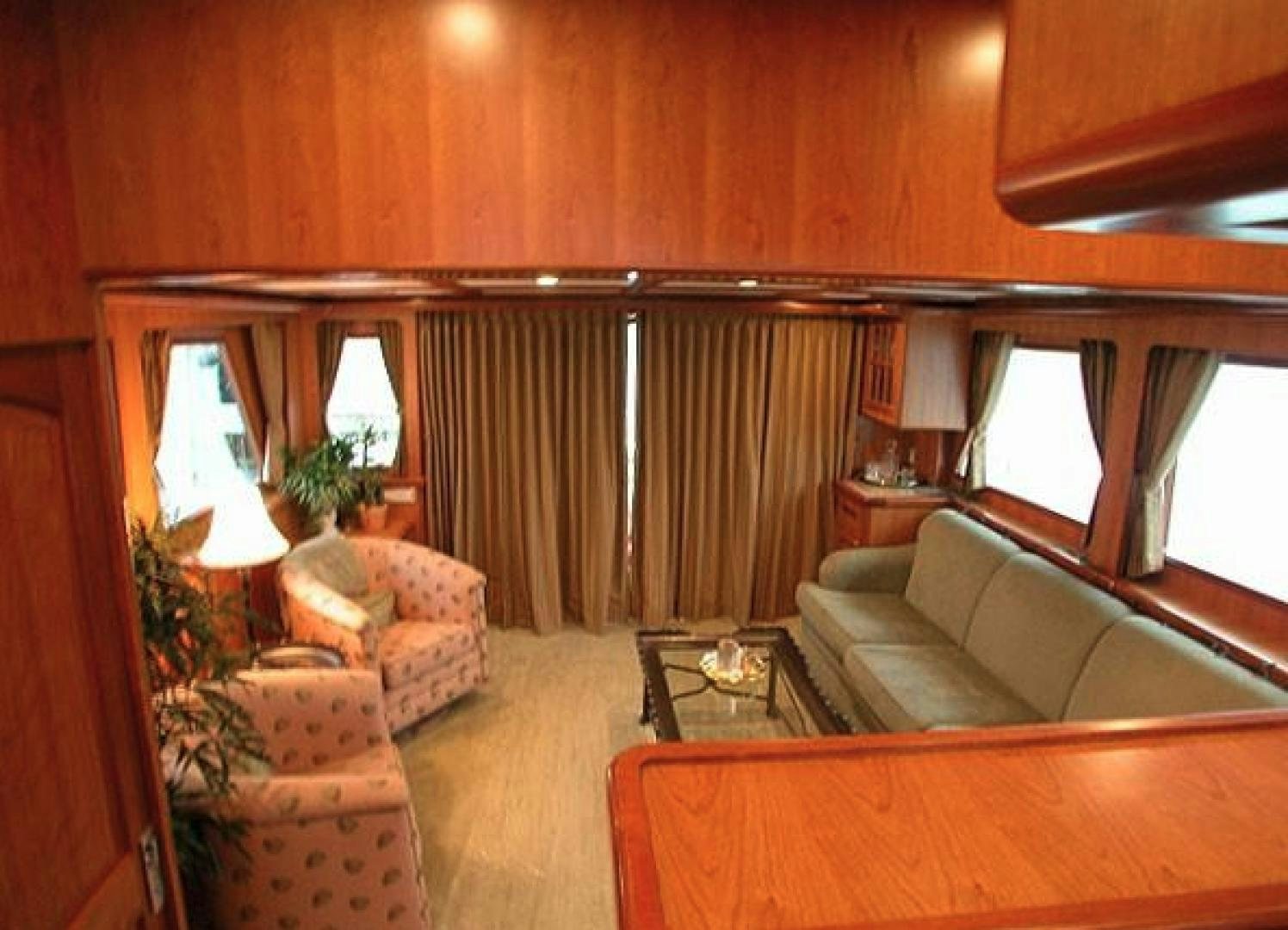 a living room with a couch and a table aboard No Name Yacht for Sale