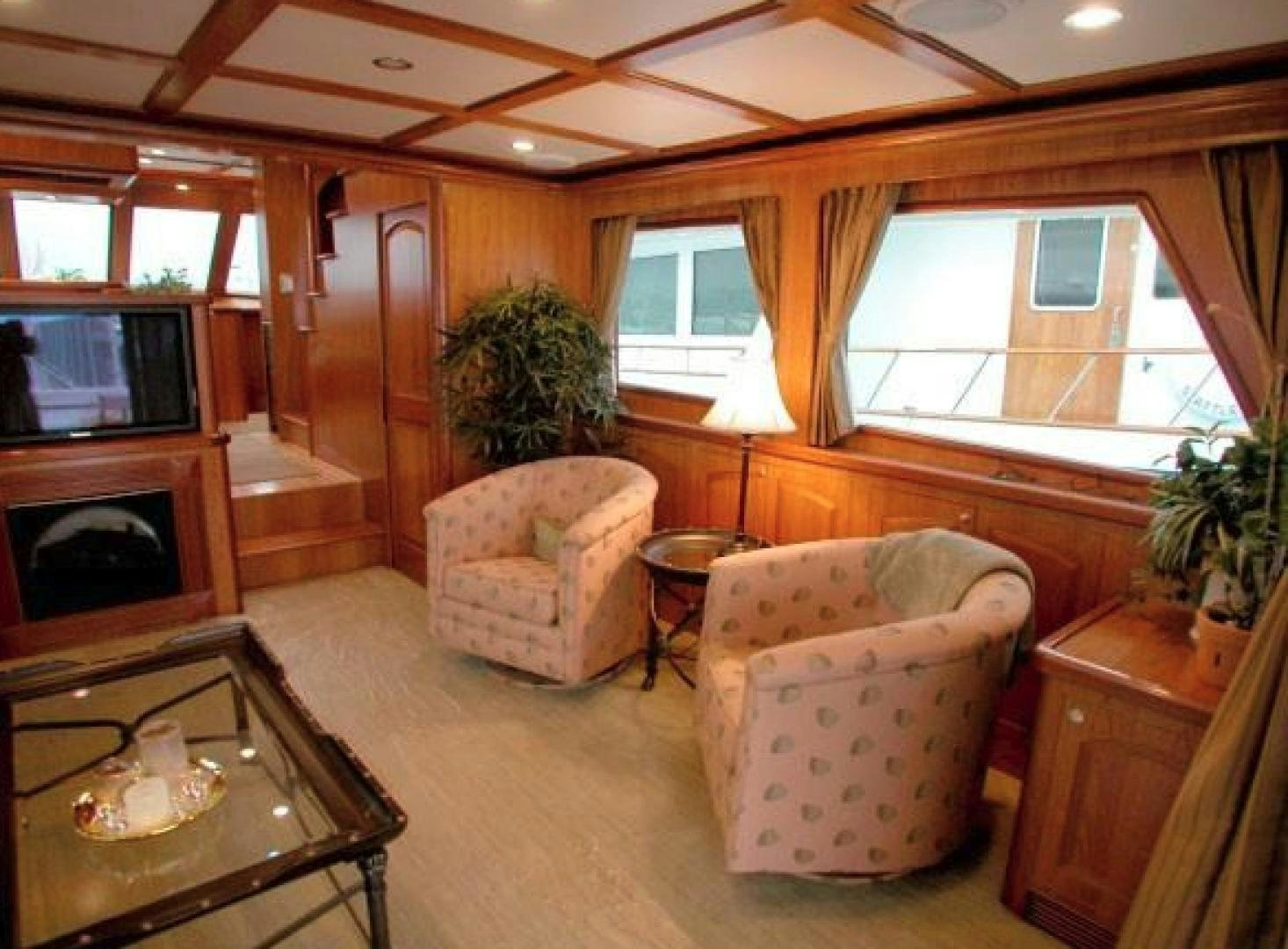 a living room with a fireplace aboard No Name Yacht for Sale