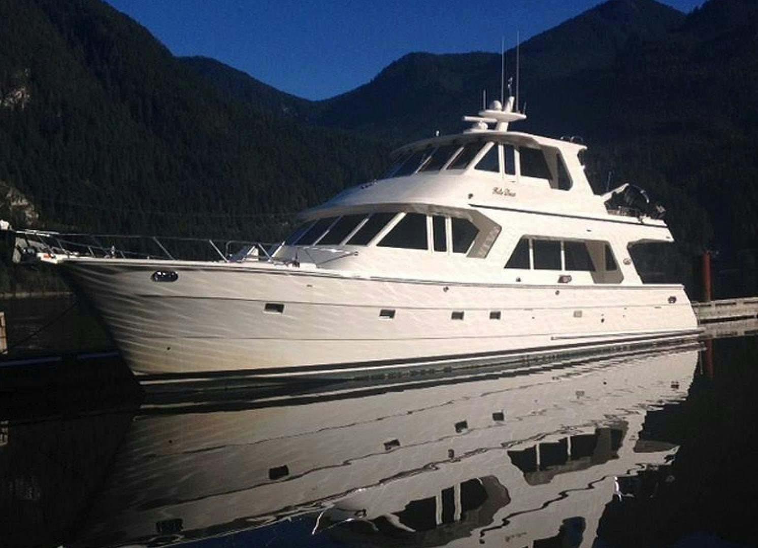a white yacht docked at a pier aboard No Name Yacht for Sale