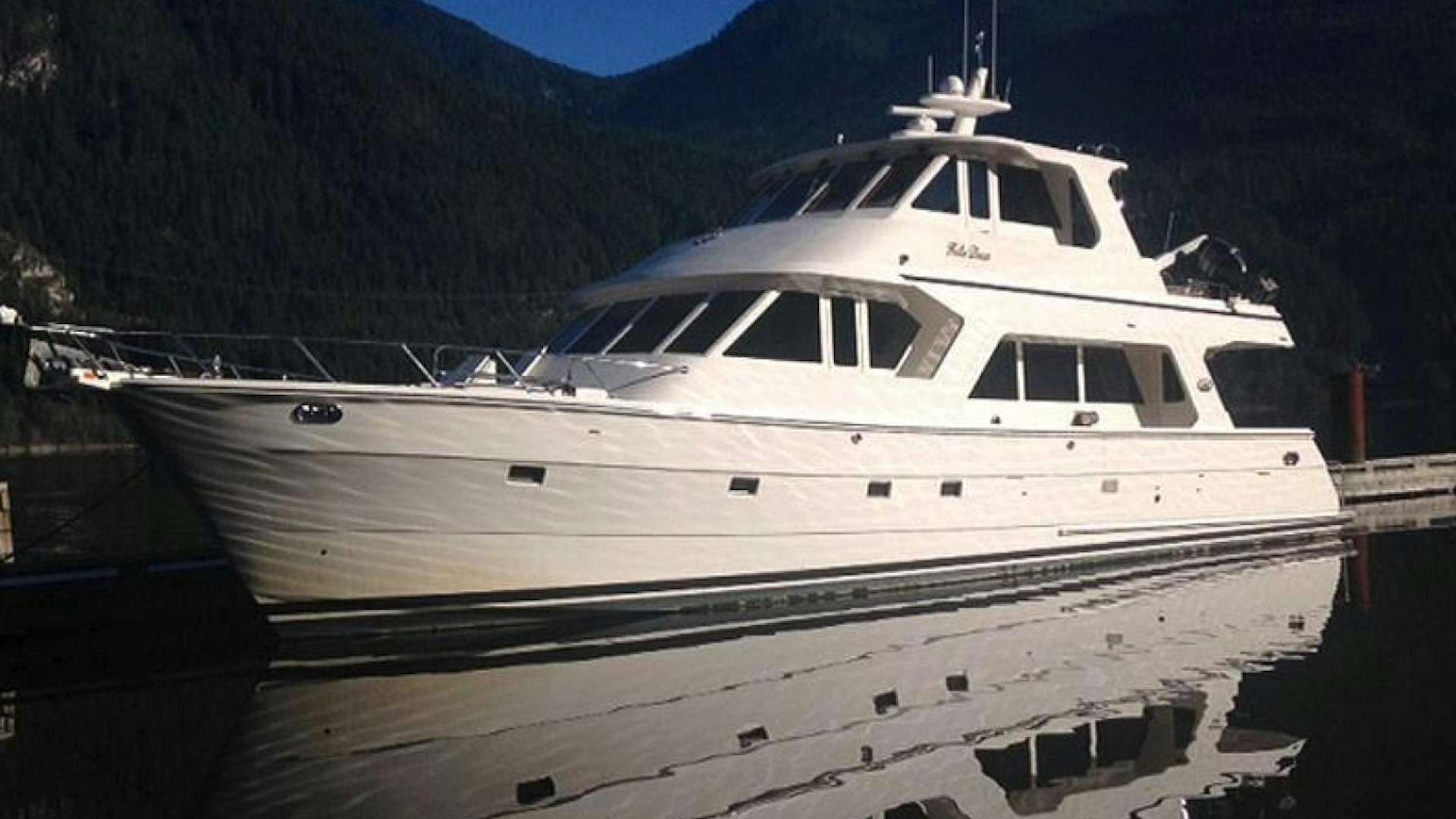 a white yacht docked at a pier aboard No Name Yacht for Sale