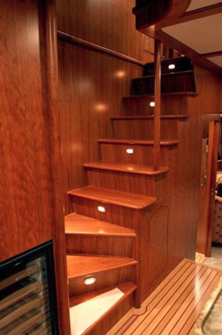 a wooden staircase with wooden railings aboard No Name Yacht for Sale