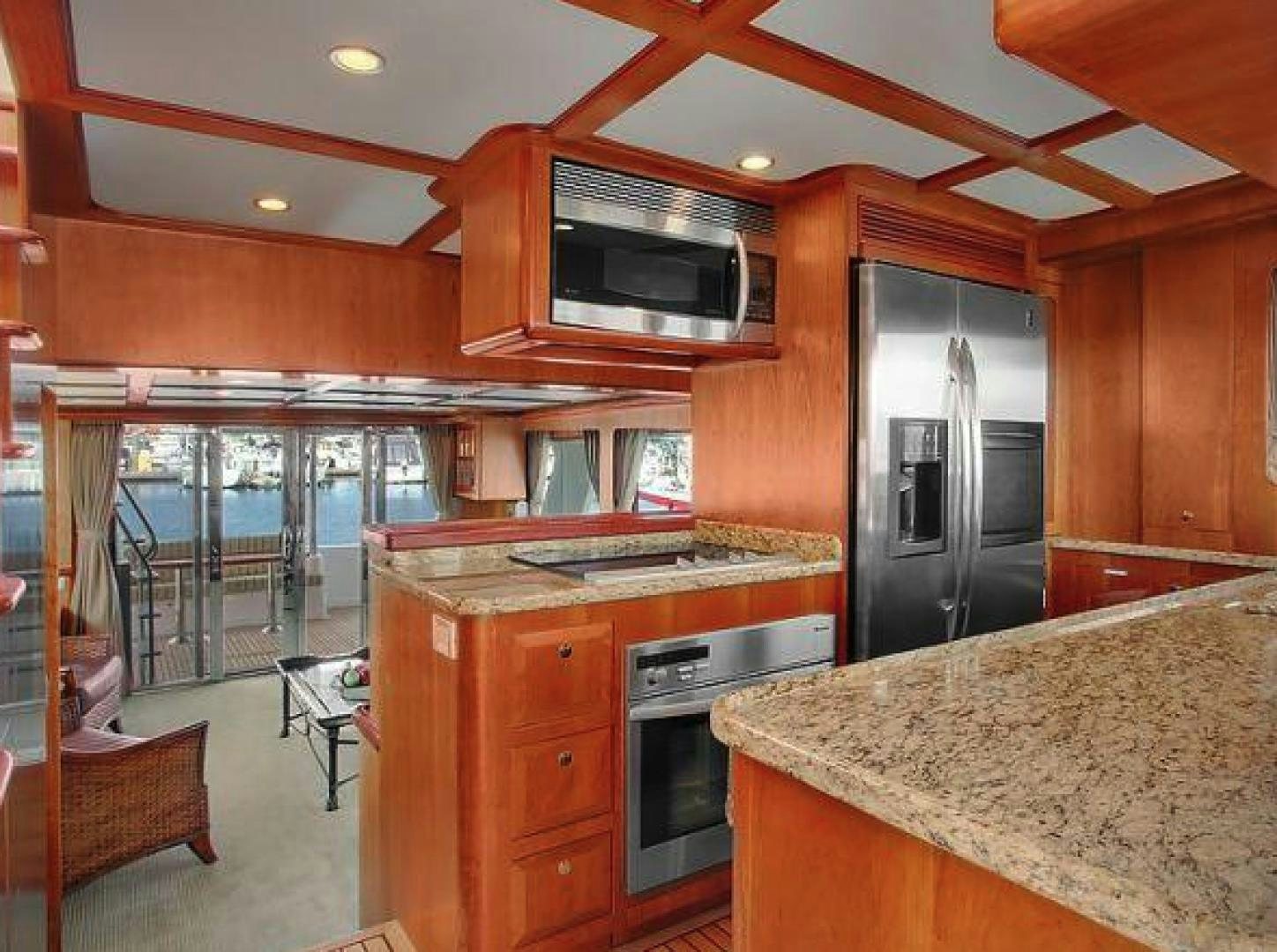 a kitchen with wooden cabinets aboard No Name Yacht for Sale