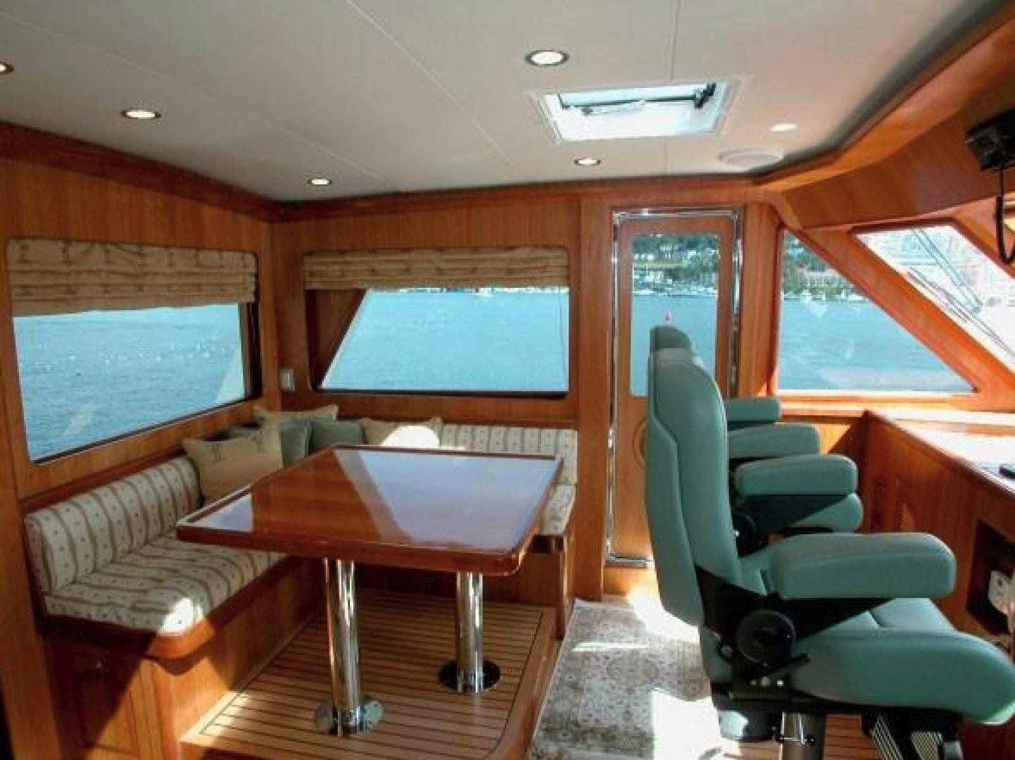 a room with a table and chairs aboard No Name Yacht for Sale