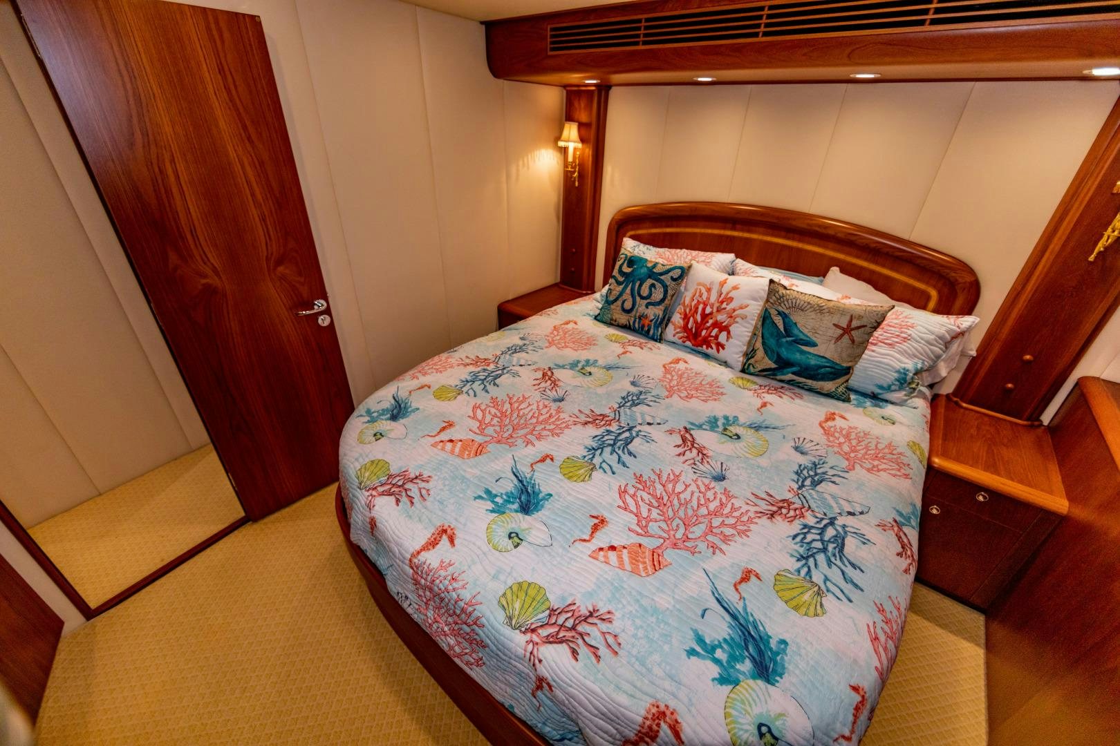 a bed with a blue comforter aboard WATASHEE Yacht for Sale
