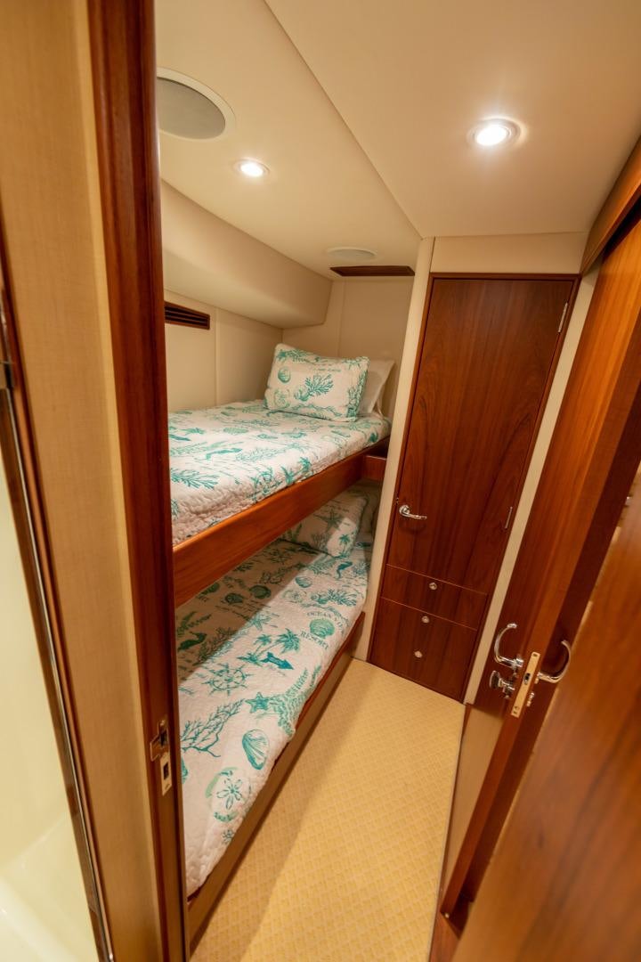 a bedroom with a bed and a closet aboard WATASHEE Yacht for Sale