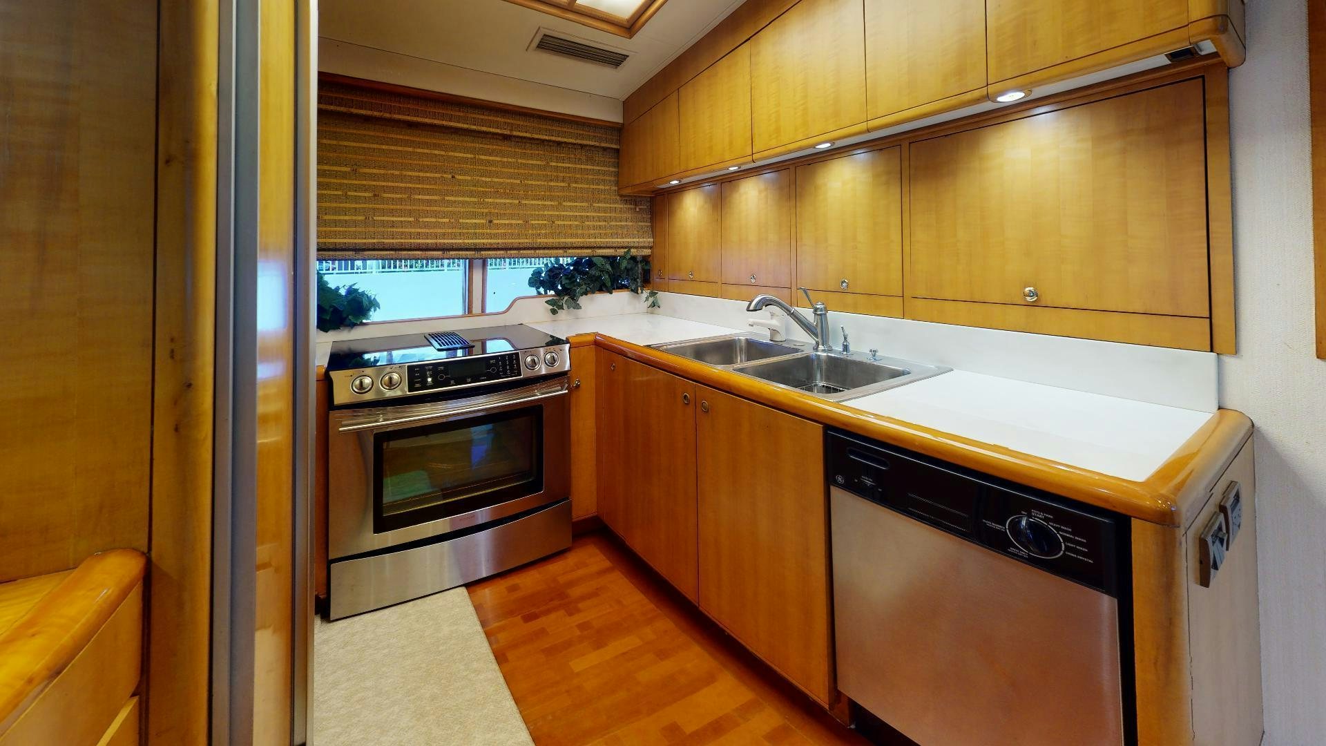 a kitchen with wooden cabinets aboard clean sweep Yacht for Sale