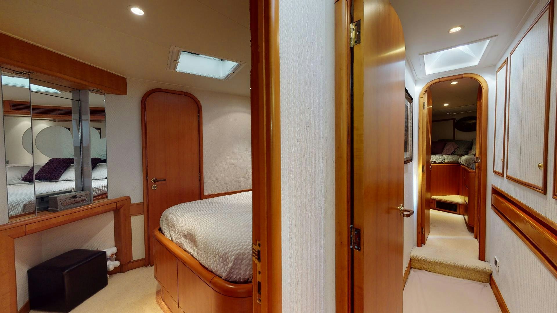 a bedroom with a bed and a mirror aboard clean sweep Yacht for Sale