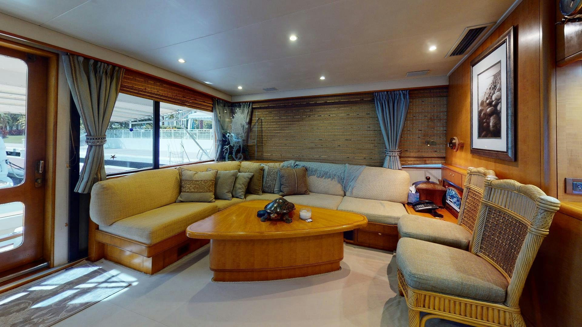 a living room with a couch and a table aboard clean sweep Yacht for Sale