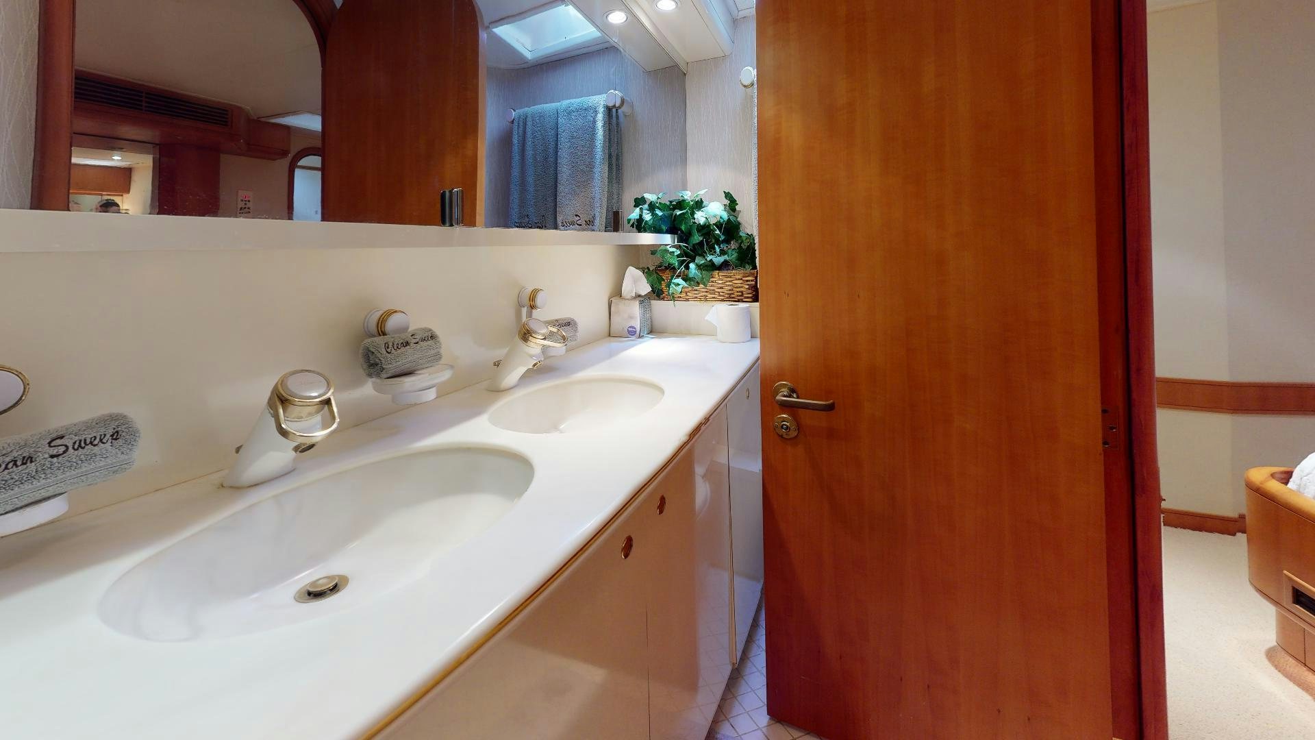 a bathroom with a sink and a mirror aboard clean sweep Yacht for Sale