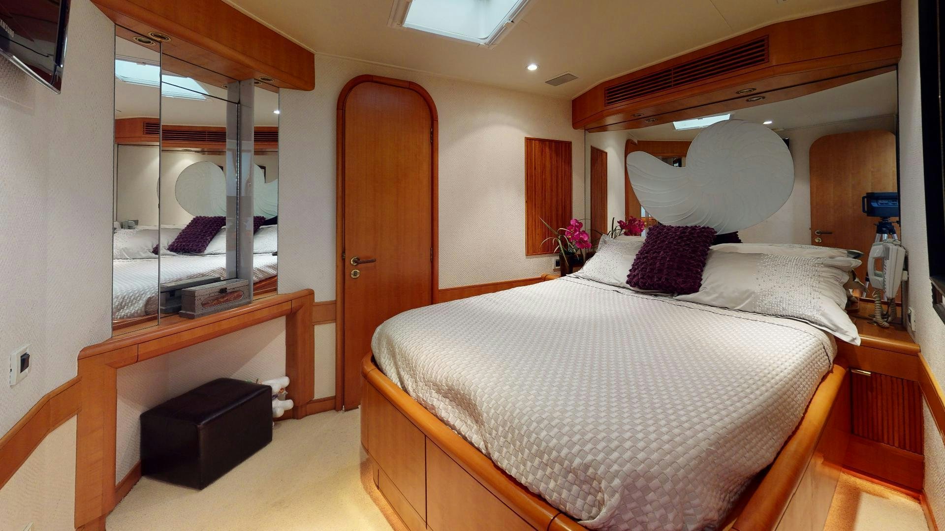 a bedroom with a large mirror aboard clean sweep Yacht for Sale