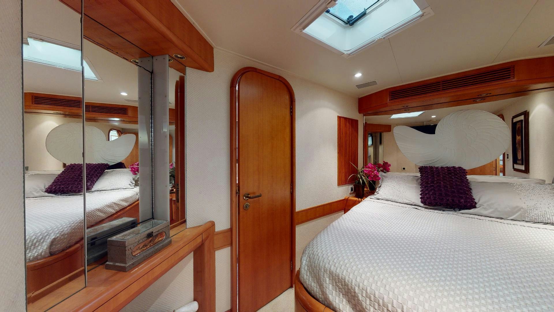 a room with a bed and a mirror aboard clean sweep Yacht for Sale