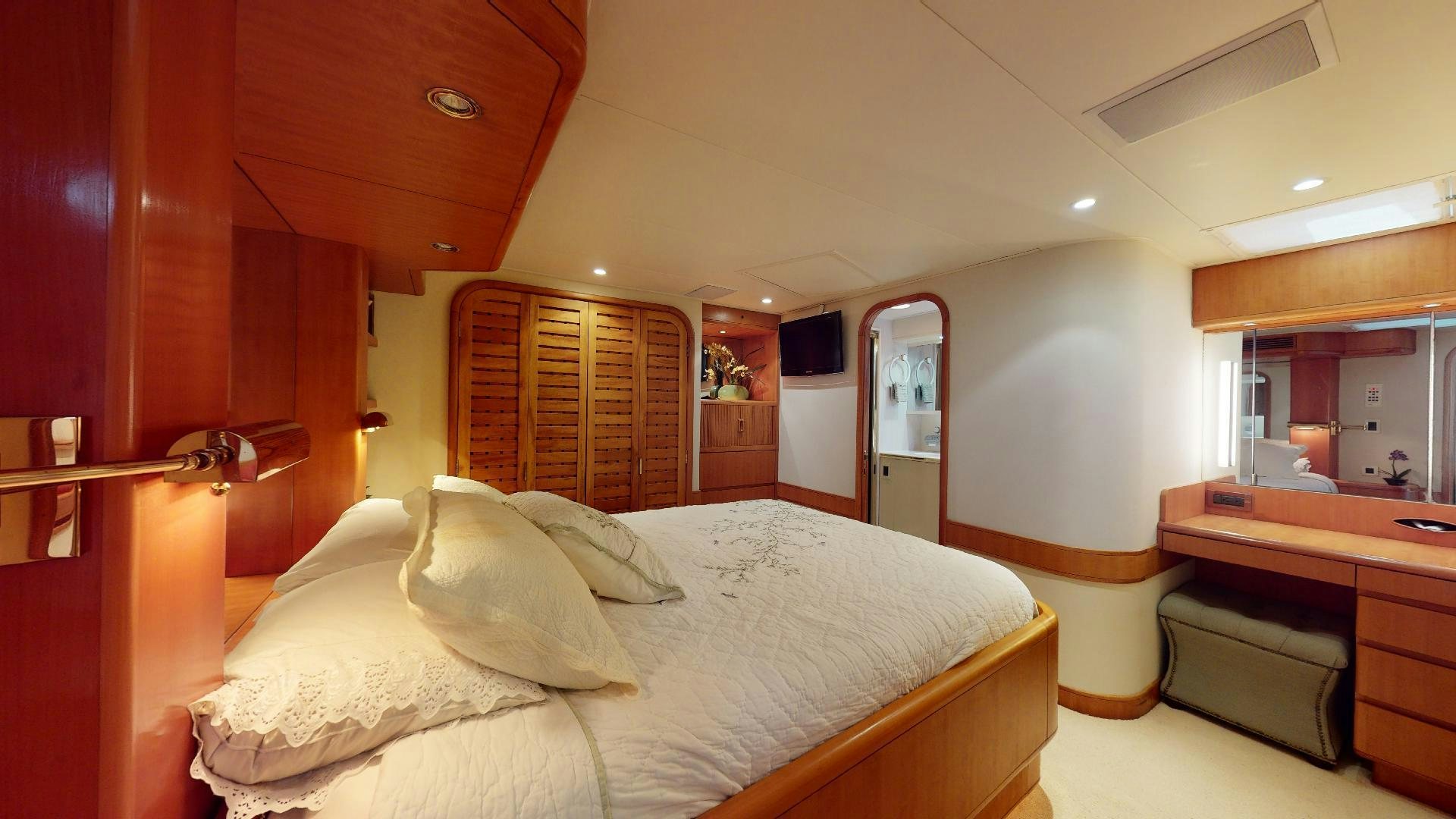 a bedroom with a bed and a desk aboard clean sweep Yacht for Sale