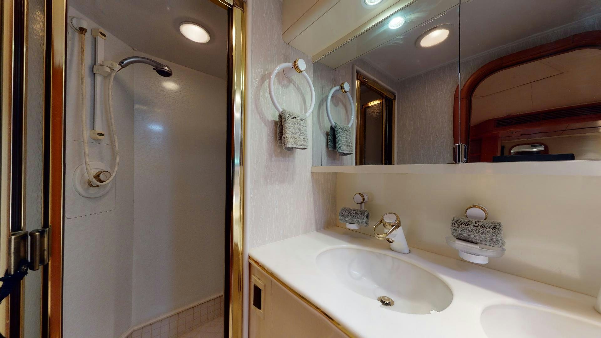 a bathroom with a large mirror aboard clean sweep Yacht for Sale
