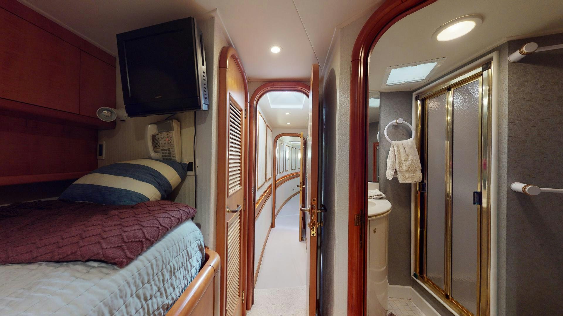 a bathroom with a bed and a television aboard clean sweep Yacht for Sale