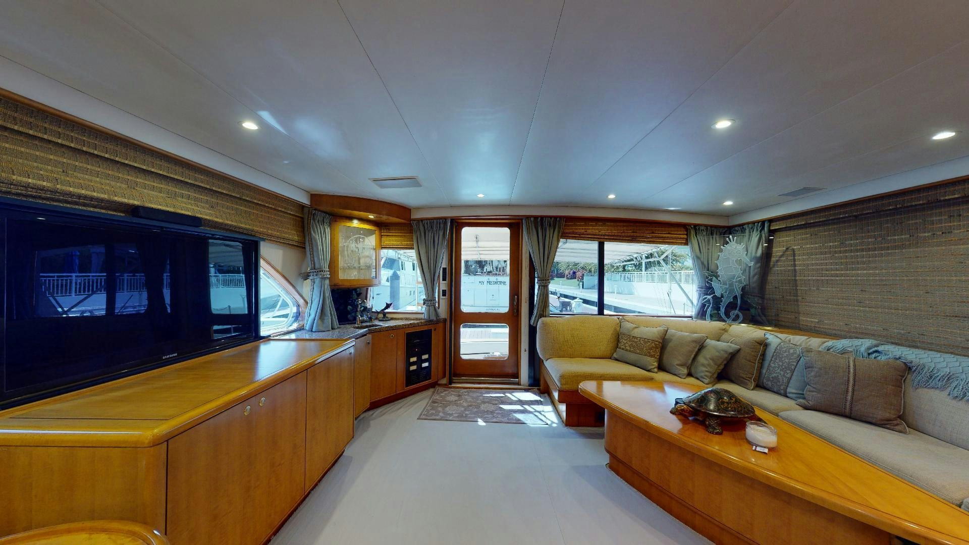 a living room with a large tv aboard clean sweep Yacht for Sale
