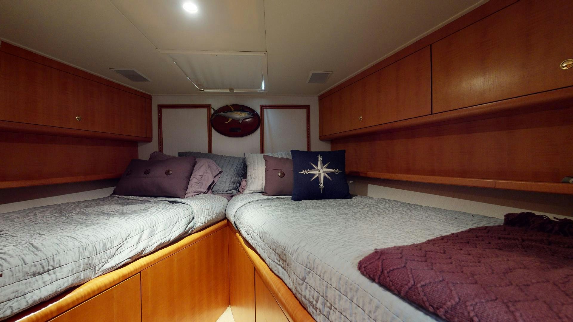 a couple of beds in a room aboard clean sweep Yacht for Sale