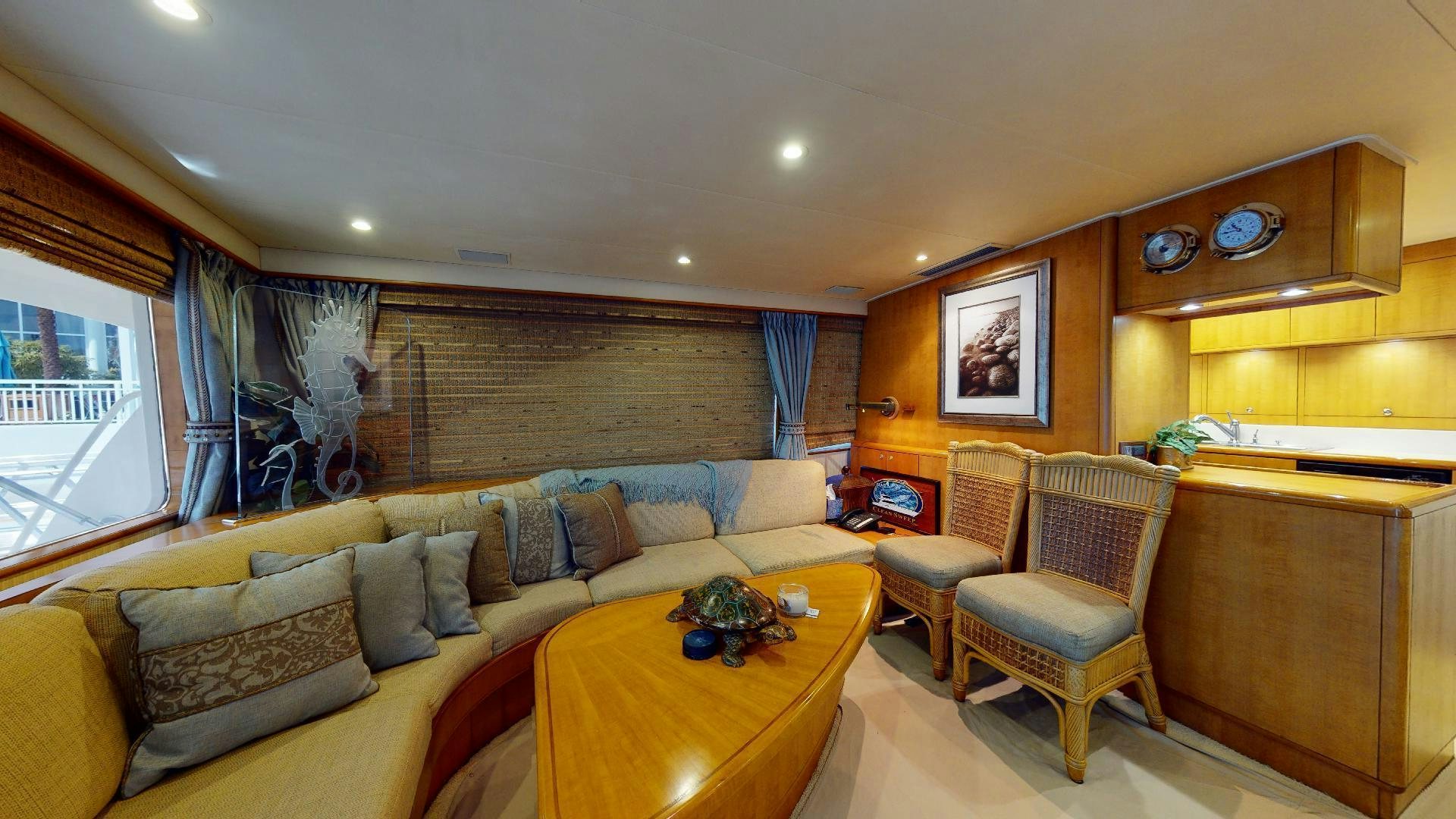 a living room with a couch and a table aboard clean sweep Yacht for Sale