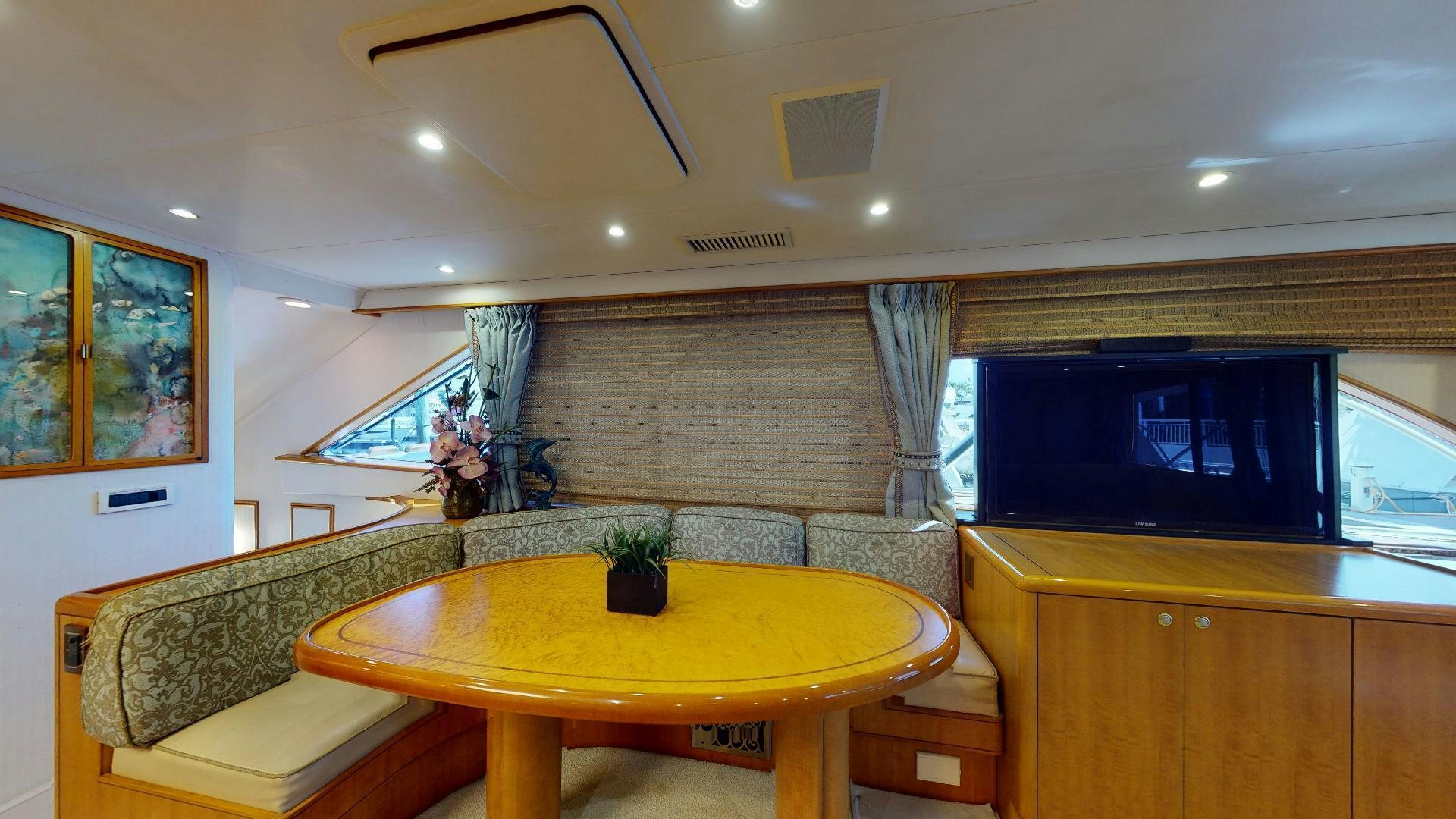 a room with a table and couches aboard clean sweep Yacht for Sale