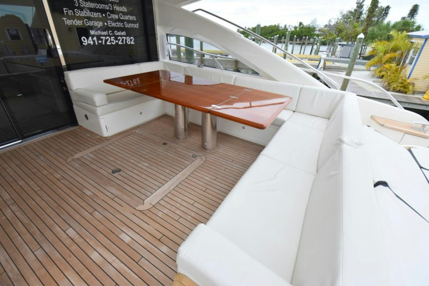 a white bed on a wooden deck aboard No Name Yacht for Sale