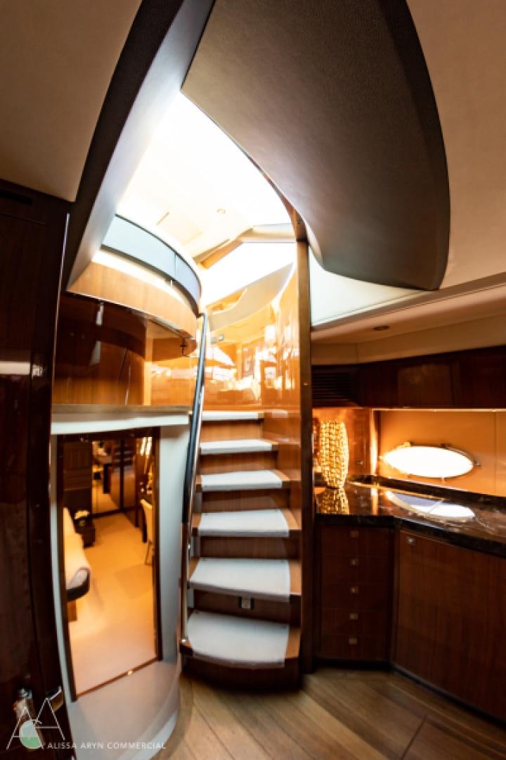 a wooden staircase in a house aboard No Name Yacht for Sale