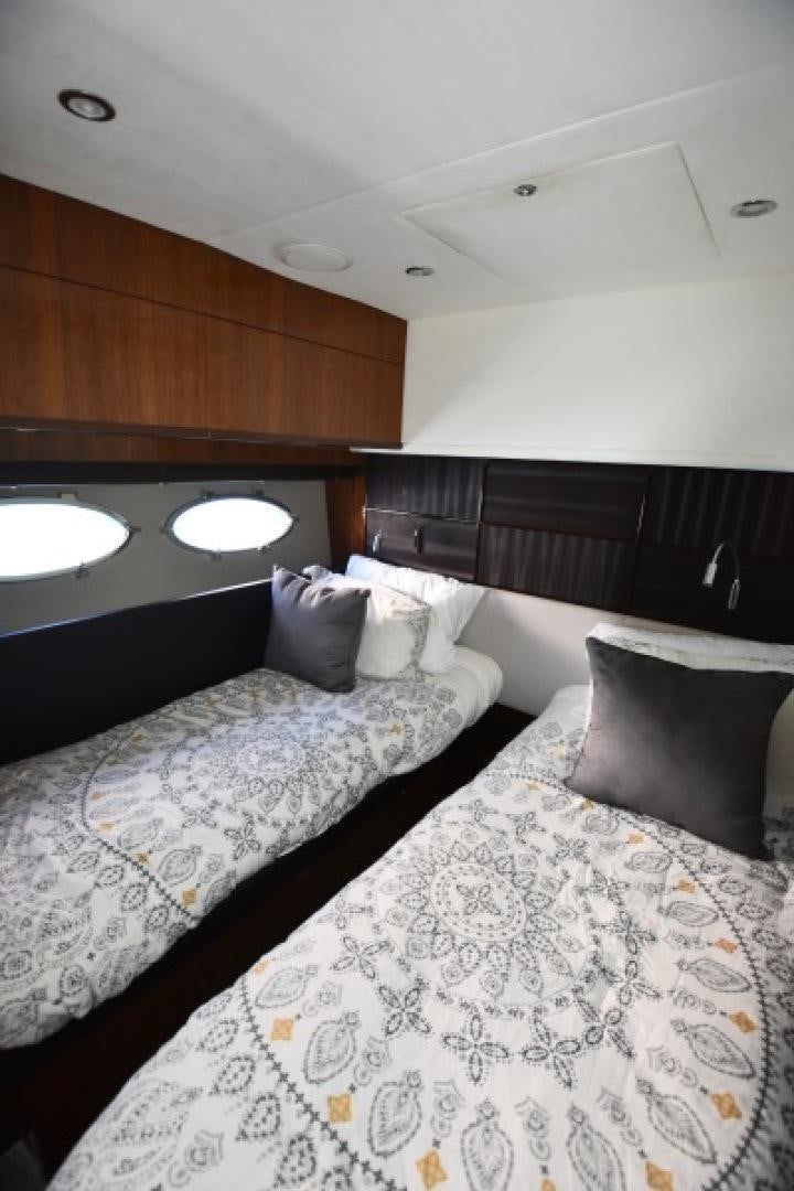 a room with a bed and a wood wall aboard No Name Yacht for Sale