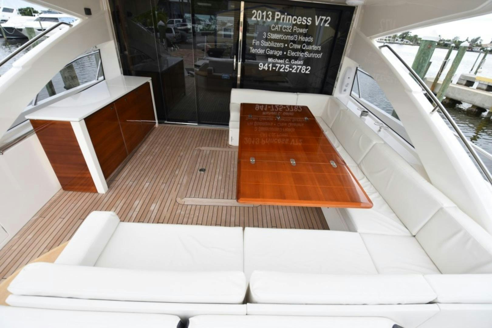 a room with a bench and a table with books on it aboard No Name Yacht for Sale