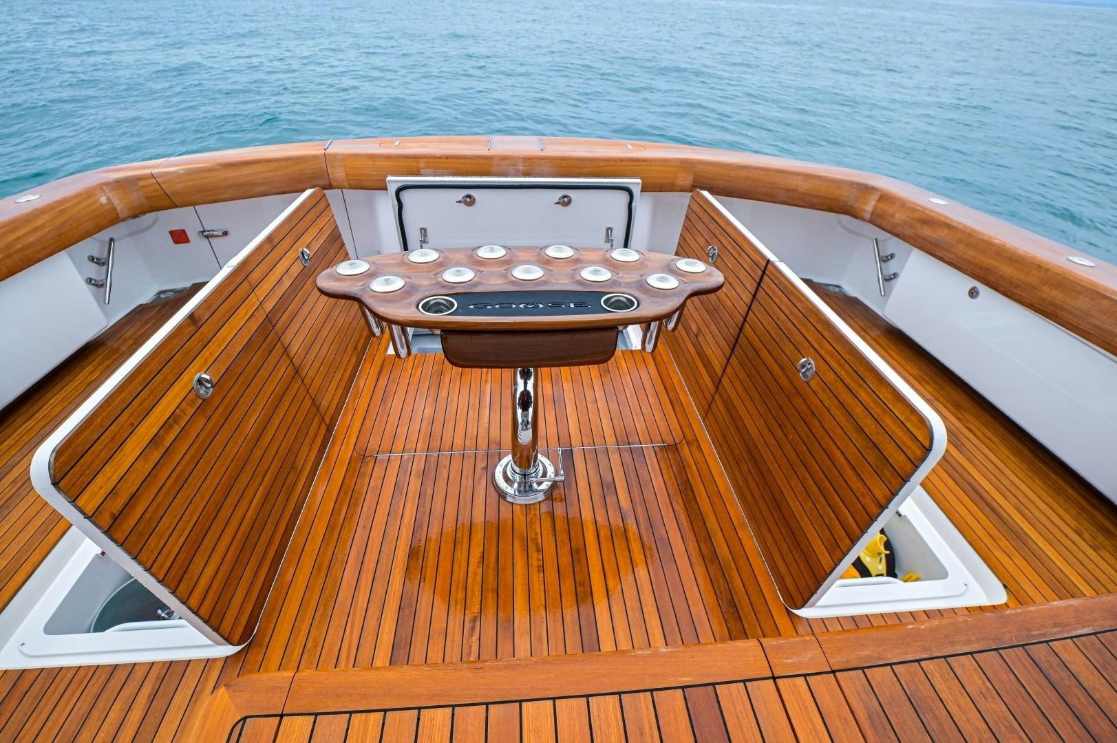 a wooden boat on a deck aboard GOOSE Yacht for Sale